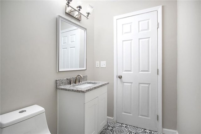 bathroom featuring toilet and vanity