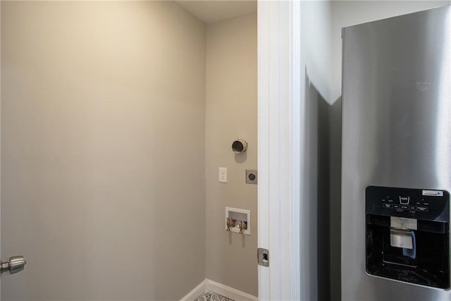 washroom featuring water heater, washer hookup, electric dryer hookup, and baseboards