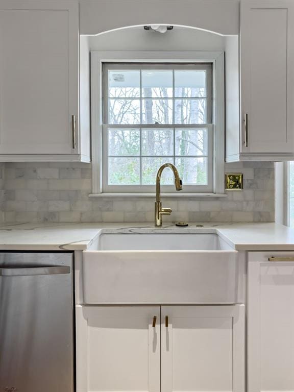 kitchen with sink, white cabinetry, backsplash, white dishwasher, and stainless steel dishwasher