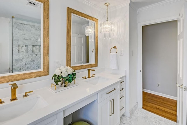 bathroom featuring an inviting chandelier, ornamental molding, and vanity