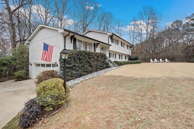 view of home's exterior with a garage and a yard