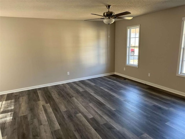 empty room featuring dark hardwood / wood-style flooring, ceiling fan, and a textured ceiling