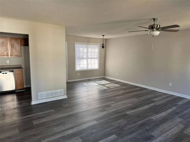 unfurnished living room featuring ceiling fan, dark wood-type flooring, and a textured ceiling