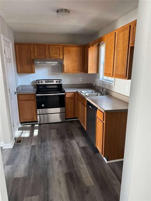 kitchen with stainless steel appliances, dark hardwood / wood-style floors, and sink