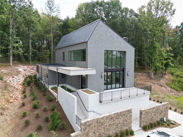 back of property featuring a balcony