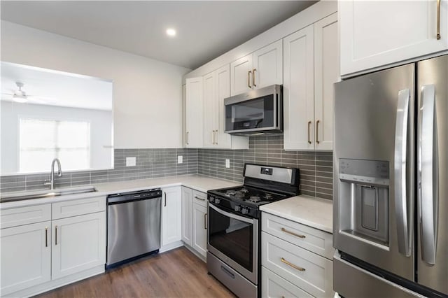 13300 Morris Rd Unit 76, Alpharetta, GA 30004 - kitchen featuring a sink, appliances with stainless steel finishes, a peninsula, and light countertops