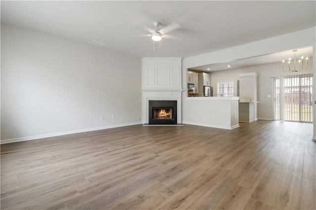 13300 Morris Rd Unit 76, Alpharetta, GA 30004 - empty room featuring baseboards, a notable chandelier, wood finished floors, and visible vents