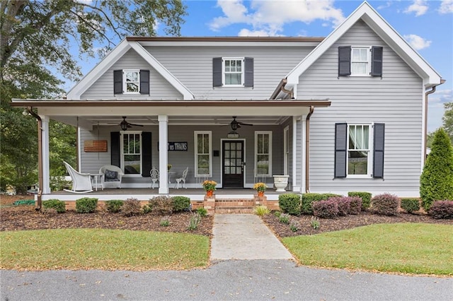 view of front of home with a porch, ceiling fan, and a front lawn