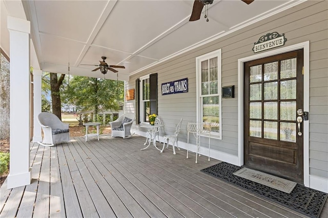 wooden deck featuring ceiling fan and covered porch