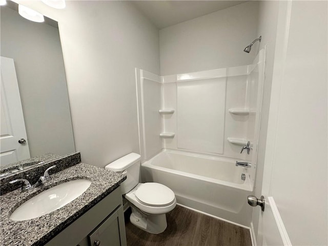 full bath featuring toilet, shower / washtub combination, wood finished floors, and vanity