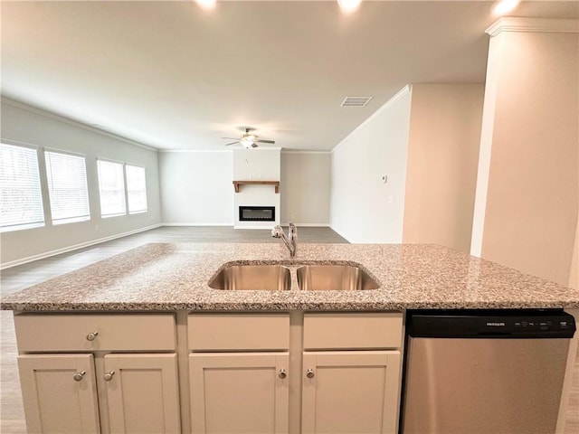 kitchen featuring visible vents, a ceiling fan, a sink, stainless steel dishwasher, and open floor plan