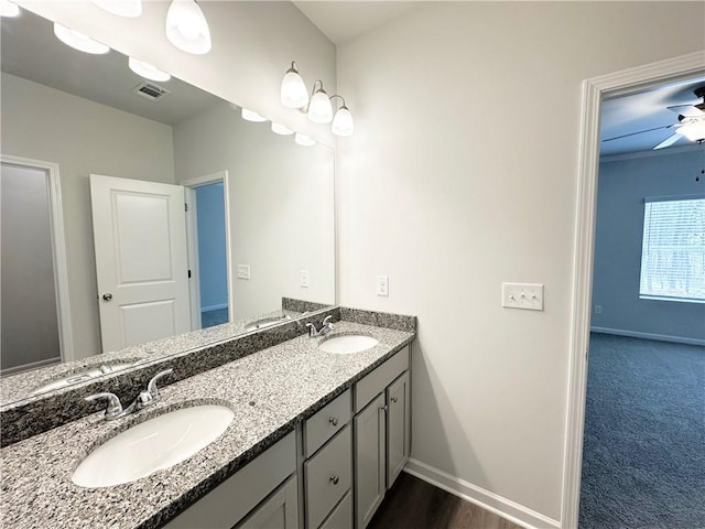 bathroom featuring visible vents, baseboards, and a sink