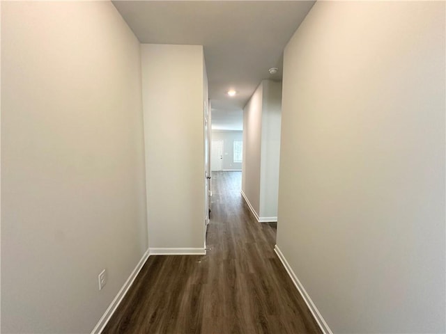 hallway with recessed lighting, baseboards, and dark wood-style flooring