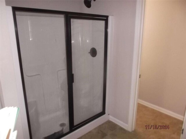 bathroom featuring a shower with shower door