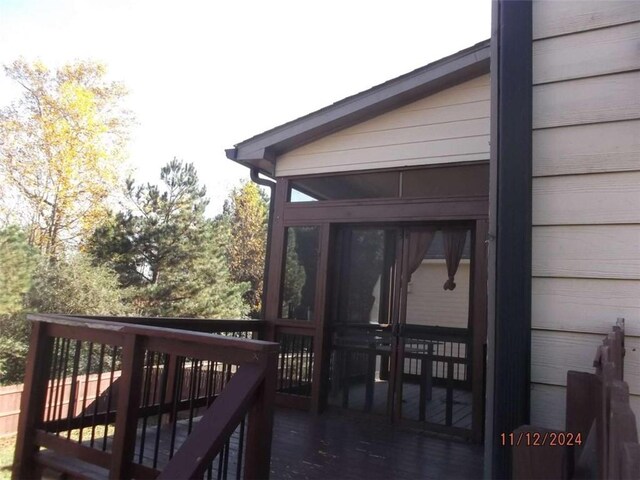 wooden terrace featuring a sunroom