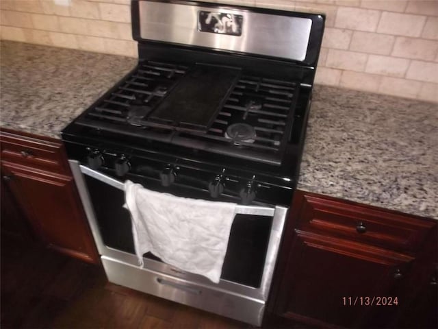 room details featuring tasteful backsplash, light stone countertops, and stainless steel gas range