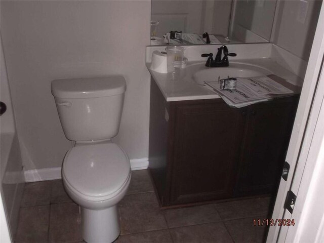 bathroom featuring tile patterned floors, vanity, and toilet