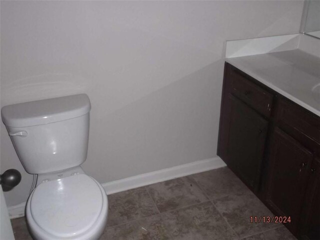 bathroom featuring tile patterned flooring, vanity, and toilet