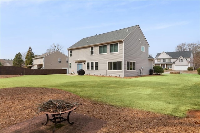 rear view of house with a yard, a patio area, and fence