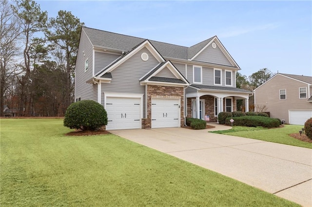 view of front of home featuring a porch, an attached garage, stone siding, driveway, and a front lawn