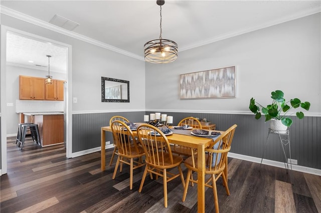 dining area with a wainscoted wall, dark wood-style floors, and crown molding