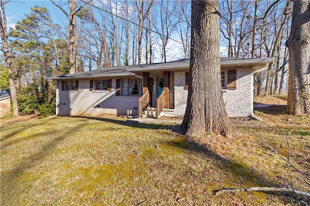 single story home featuring brick siding, crawl space, and a front yard