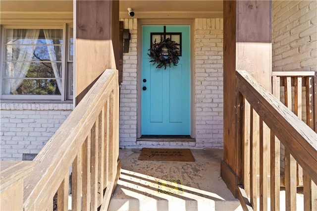 property entrance featuring brick siding