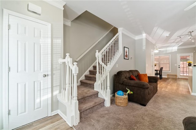 living room with light colored carpet, ceiling fan, and crown molding