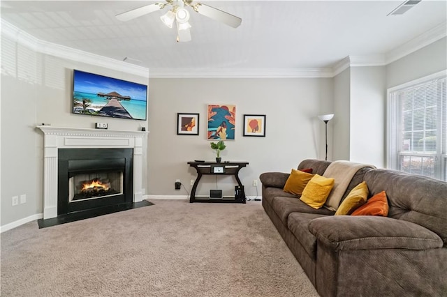 carpeted living room featuring ceiling fan and ornamental molding