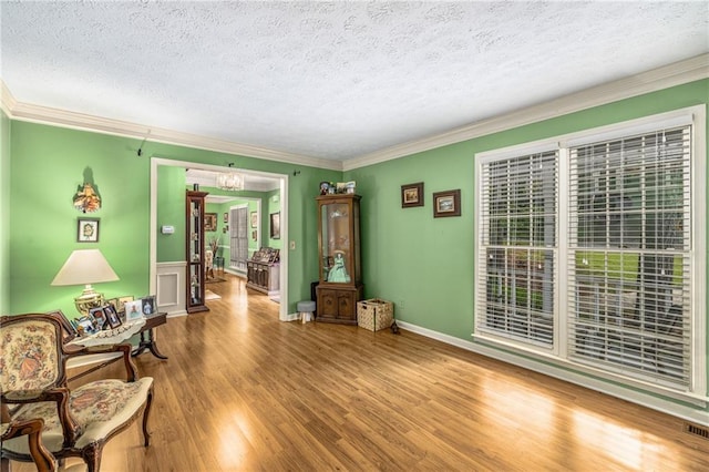 1519 Brookcliff Cir, Marietta, GA 30062 - sitting room featuring visible vents, ornamental molding, wood finished floors, a textured ceiling, and a notable chandelier