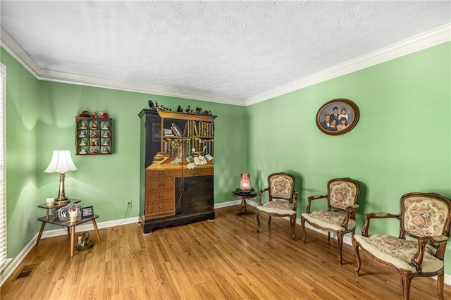 1519 Brookcliff Cir, Marietta, GA 30062 - living area with a textured ceiling, visible vents, wood finished floors, baseboards, and ornamental molding
