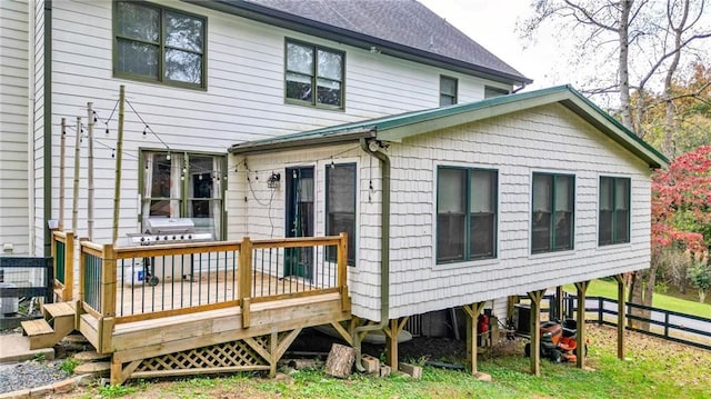 rear view of property with a wooden deck and central AC