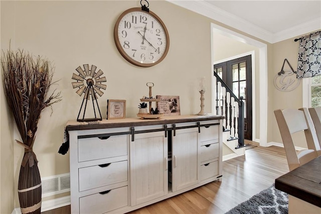 interior space with wood-type flooring and ornamental molding