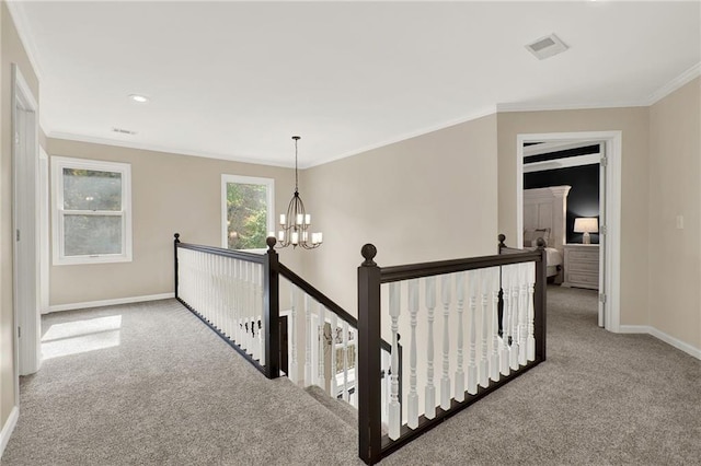 corridor featuring carpet flooring, a notable chandelier, and crown molding