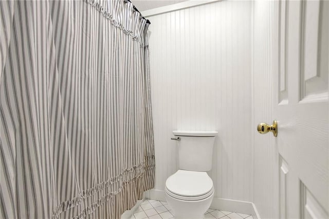 bathroom featuring toilet, tile patterned floors, and walk in shower