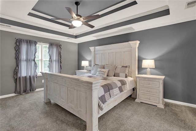 carpeted bedroom with a raised ceiling, ceiling fan, and crown molding