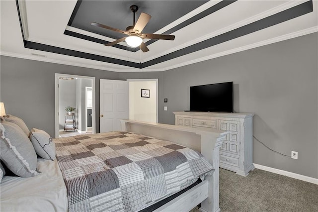 carpeted bedroom with ceiling fan, crown molding, and a tray ceiling