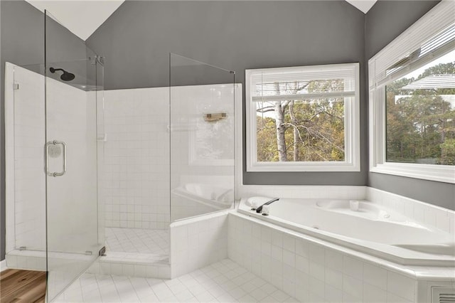 bathroom featuring vaulted ceiling and shower with separate bathtub