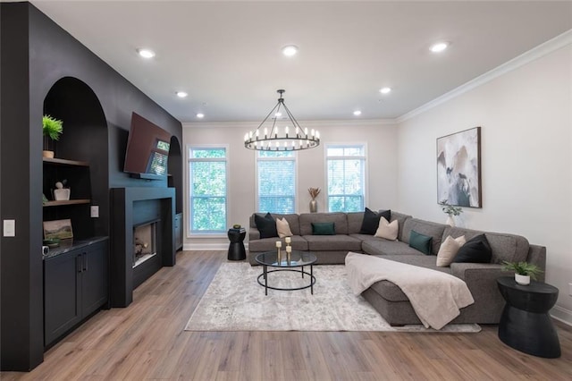 living room with crown molding and light wood-type flooring