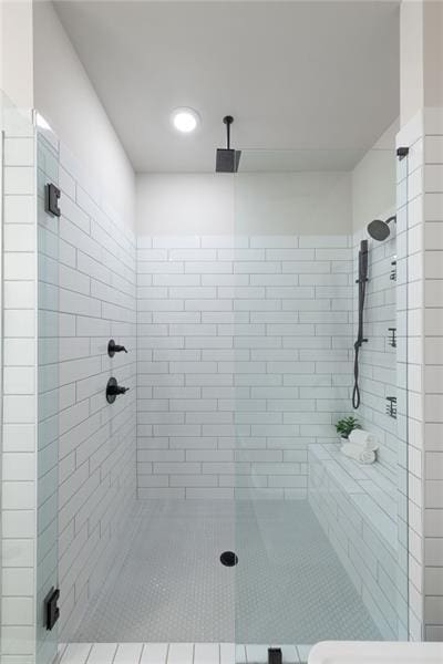 bathroom featuring a shower with door