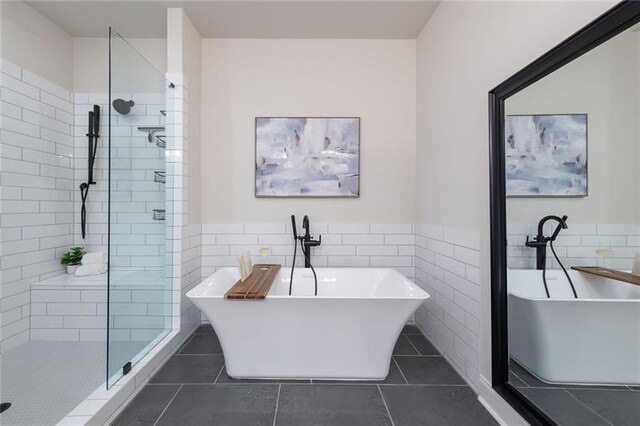 bathroom featuring shower with separate bathtub, tile patterned flooring, and tile walls