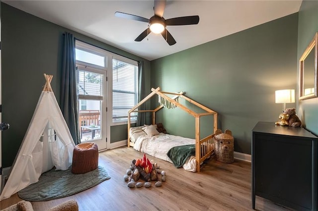 bedroom featuring ceiling fan and light hardwood / wood-style floors