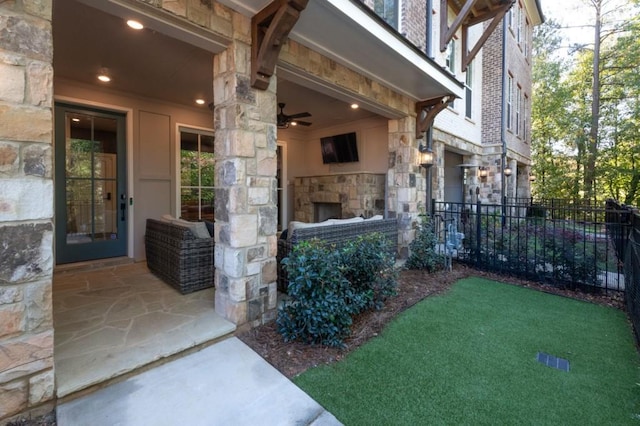 property entrance with a patio area and an outdoor stone fireplace