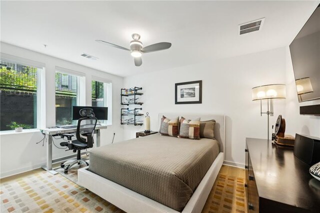 bedroom with ceiling fan and dark hardwood / wood-style floors