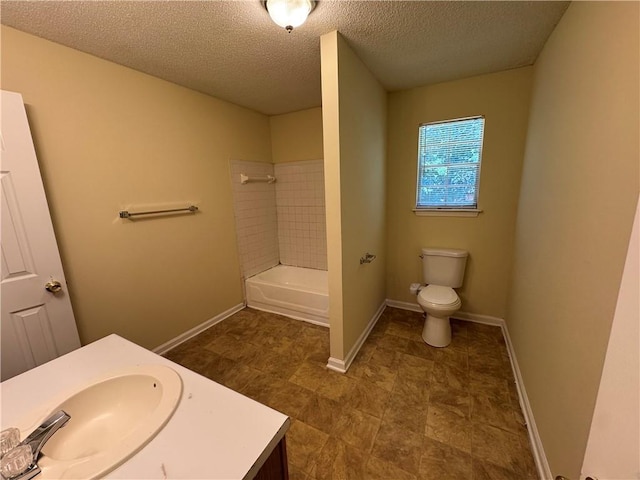 1050 Redan Trce, Stone Mountain, GA 30088 - bathroom with toilet, a textured ceiling, baseboards, vanity, and shower / bathtub combination