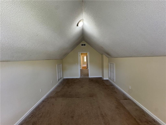 1050 Redan Trce, Stone Mountain, GA 30088 - bonus room with a textured ceiling, lofted ceiling, baseboards, and carpet flooring