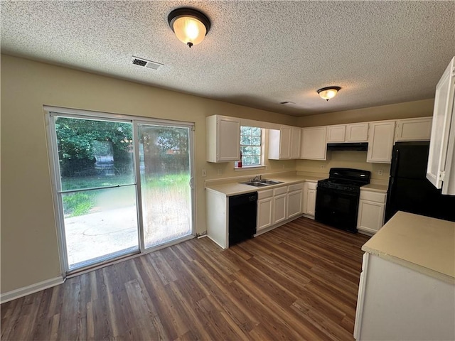 1050 Redan Trce, Stone Mountain, GA 30088 - kitchen with black appliances, light countertops, white cabinets, and a textured ceiling