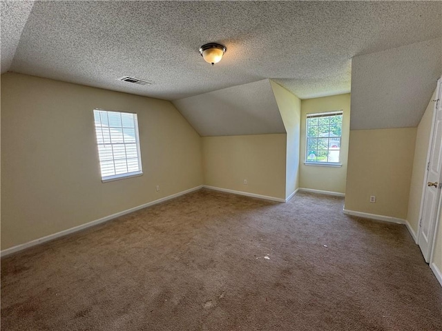 1050 Redan Trce, Stone Mountain, GA 30088 - additional living space featuring lofted ceiling, carpet, and baseboards