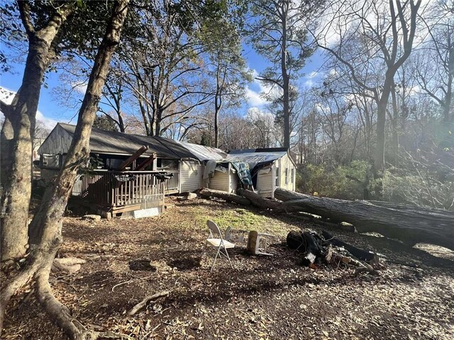 back of property featuring a wooden deck