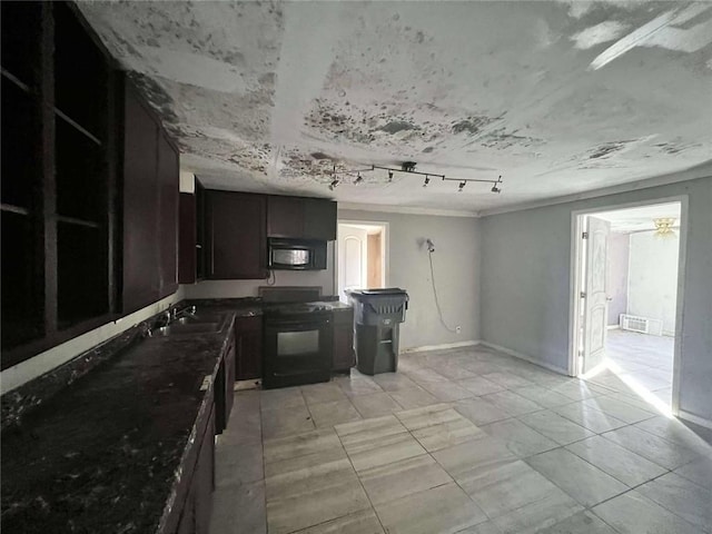 kitchen featuring dark stone counters, track lighting, black appliances, sink, and ceiling fan